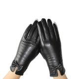 Gants en cuir noir pour femme avec un nœud décoratif.
